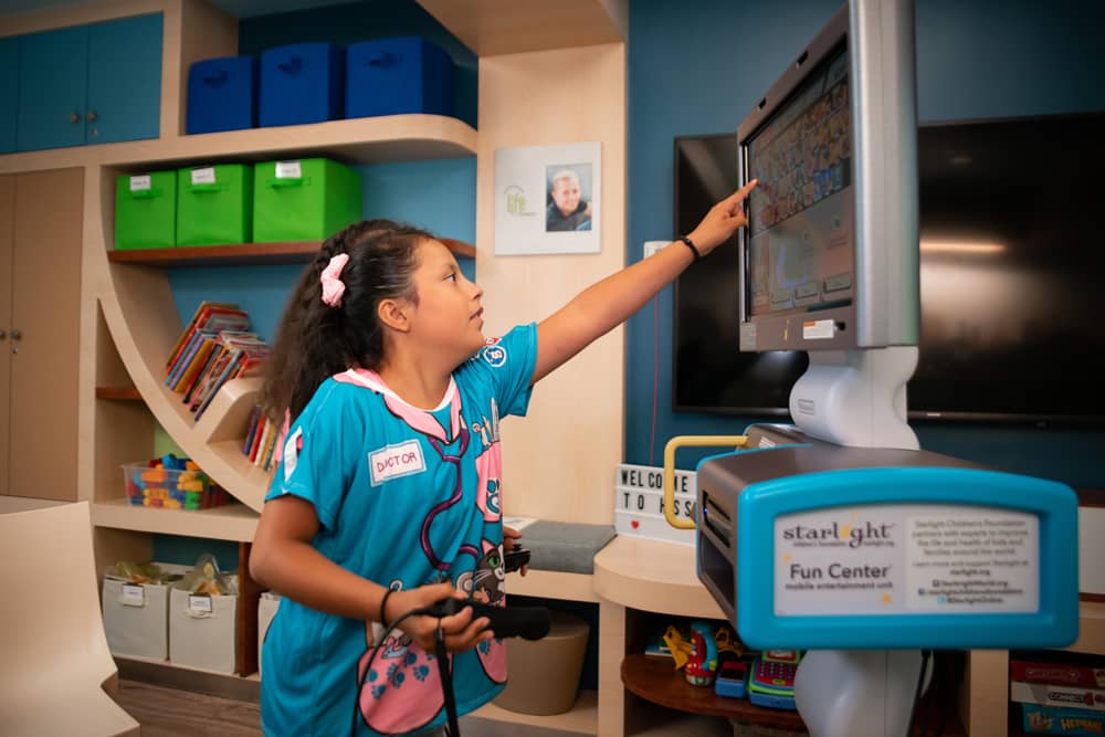 Two girls in the hospital playing with a Starlight Gaming Station